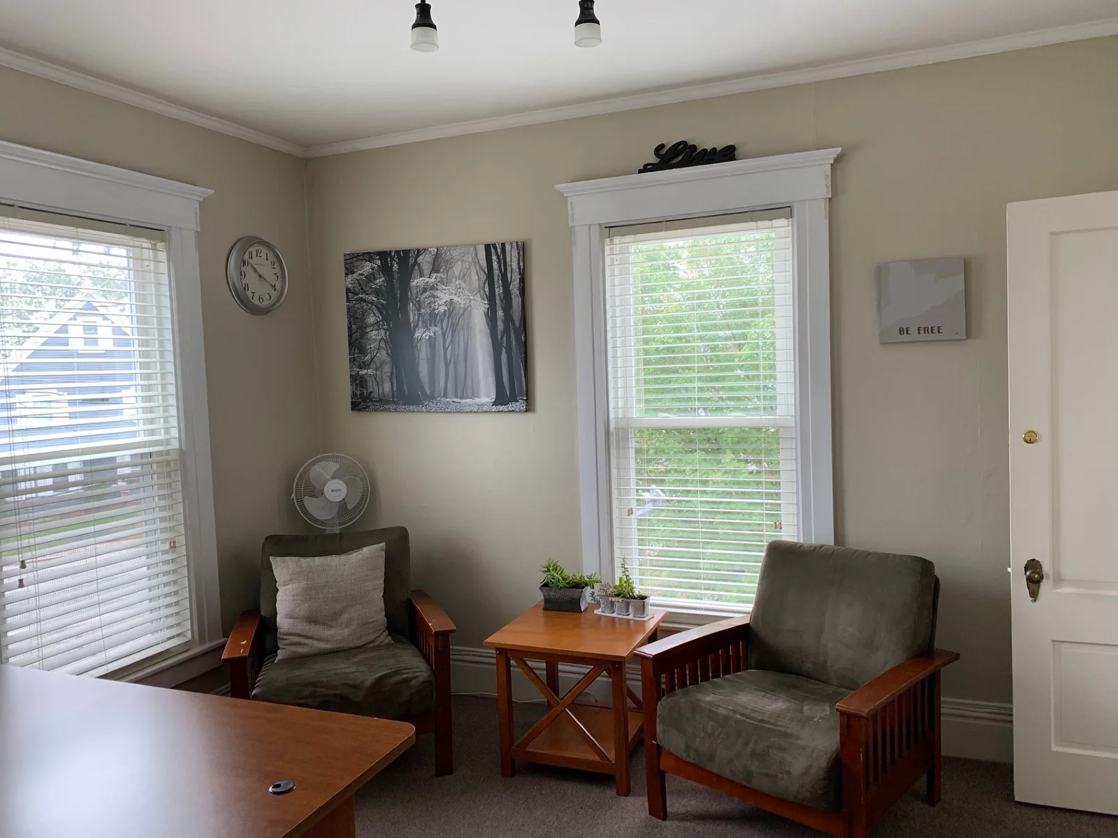Quiet counseling room with two armchairs and a small table